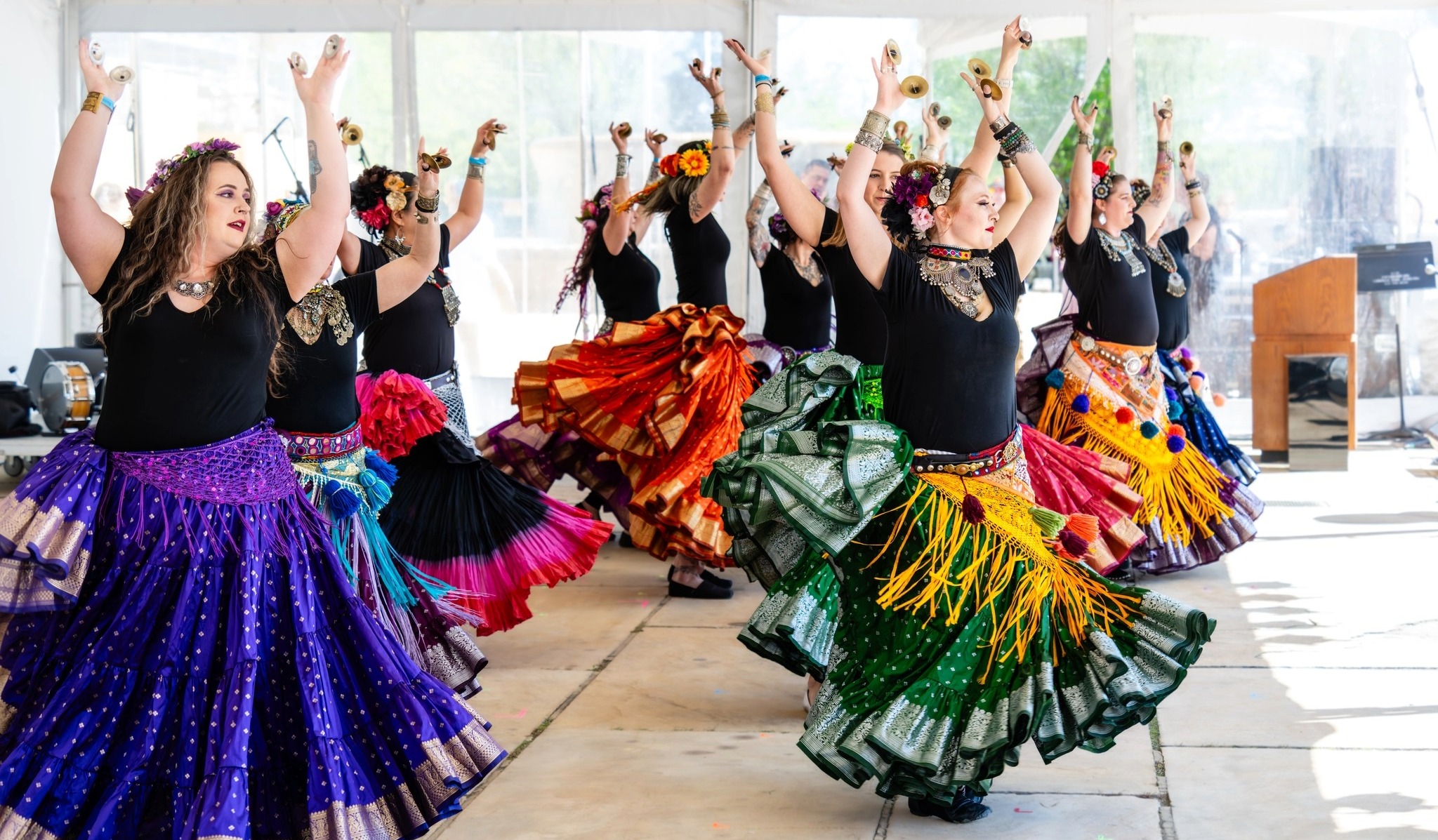 Dancers performing on stage at the Nashville Cherry Blossom Festival wearing colorful costumes during a live cultural performance.