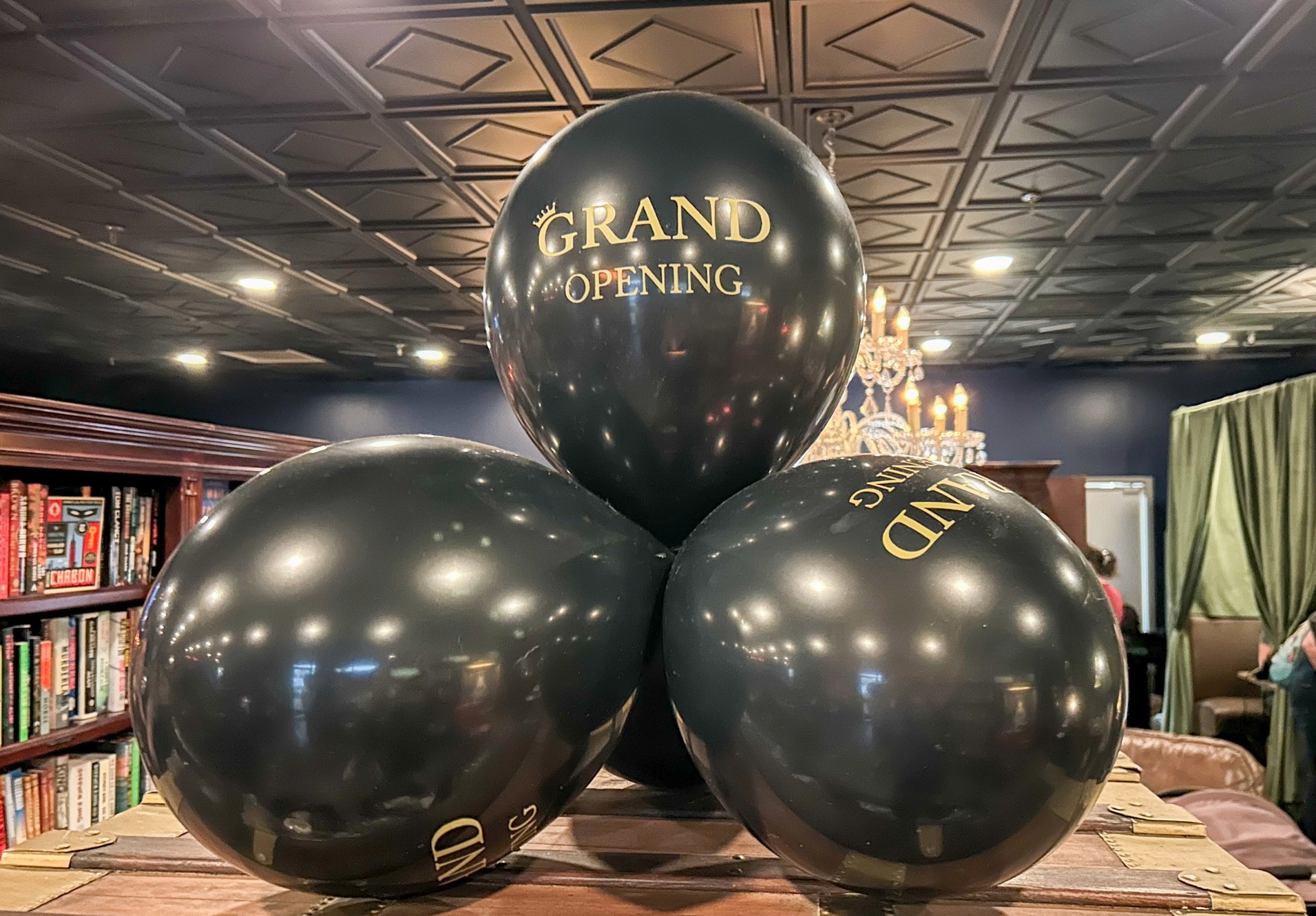 Black balloons reading “Grand Opening” inside The Raven Book Lounge in Brentwood, Tennessee