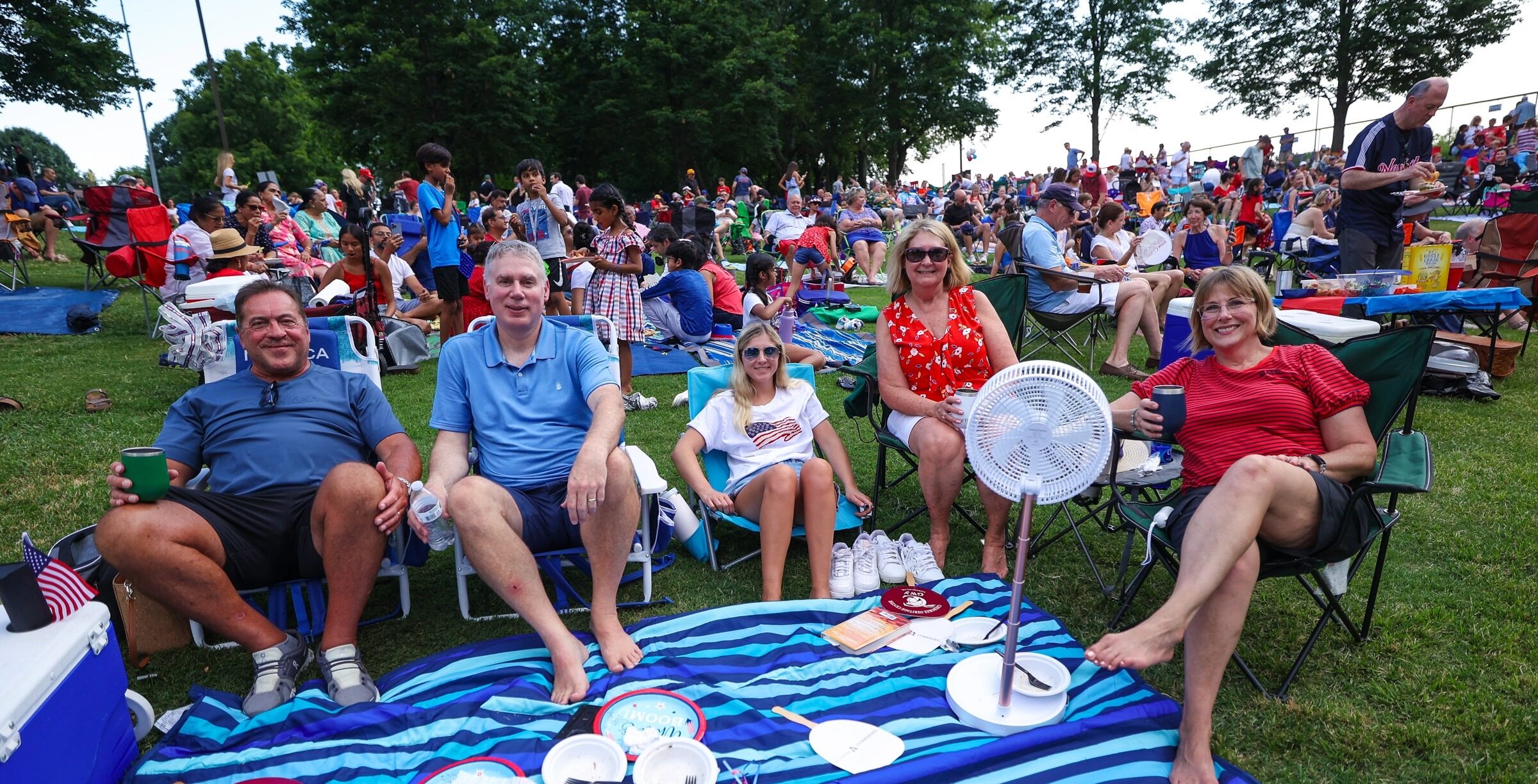 Crowd relaxing on blankets and chairs during Brentwood’s Red, White, and Boom! celebration at Crockett Park