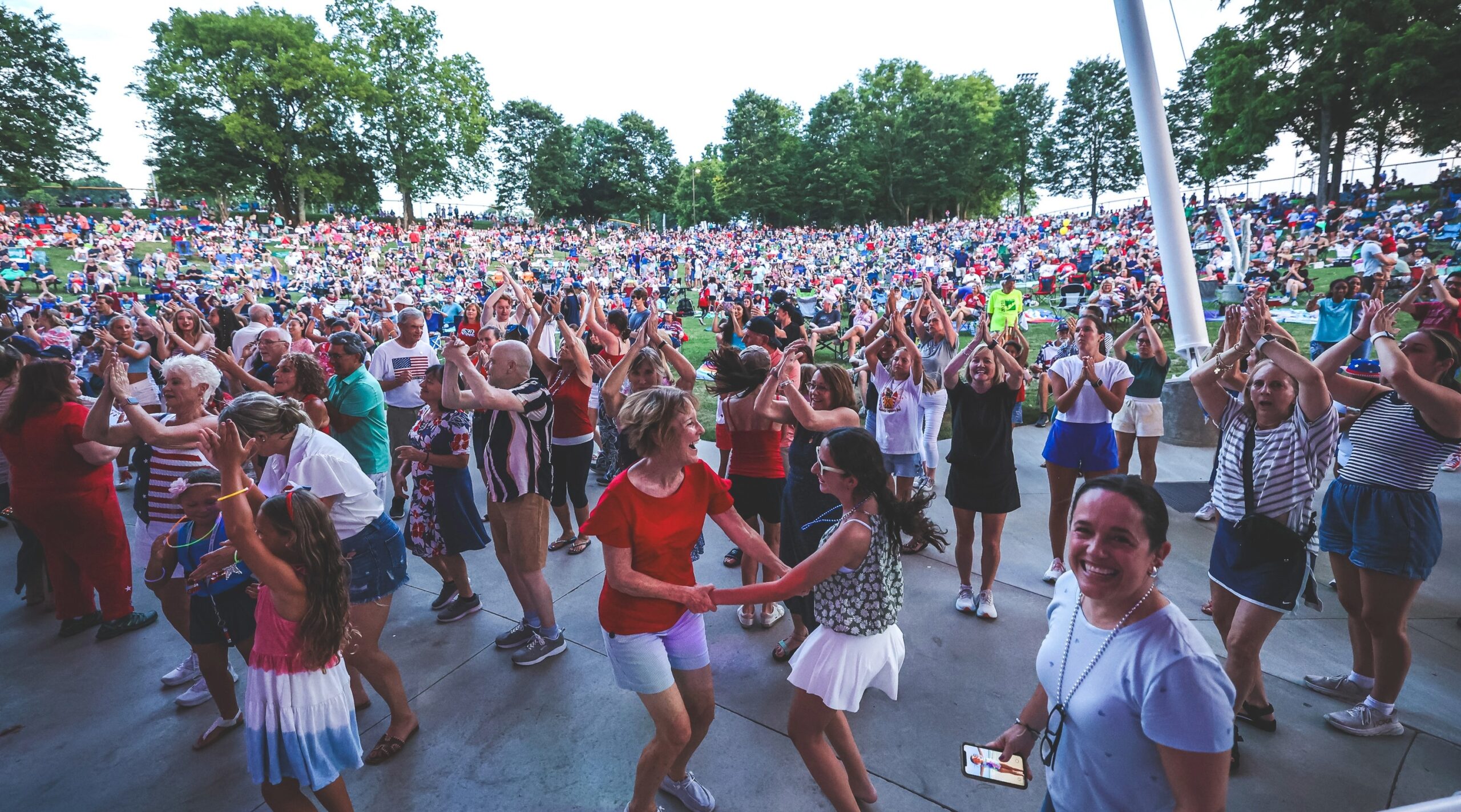 Crowd dancing and clapping along to live music at the Eddy Arnold Amphitheater during Brentwood’s Summer Concert Series at Crockett Park