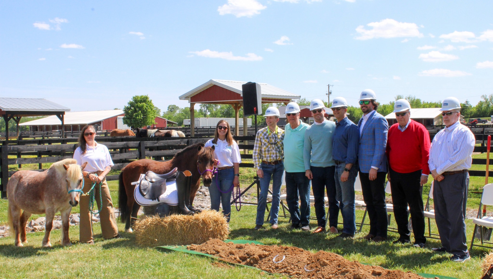 Saddle Up groundbreaking ceremony in Franklin TN with leaders, volunteers, and therapy horses at expansion site