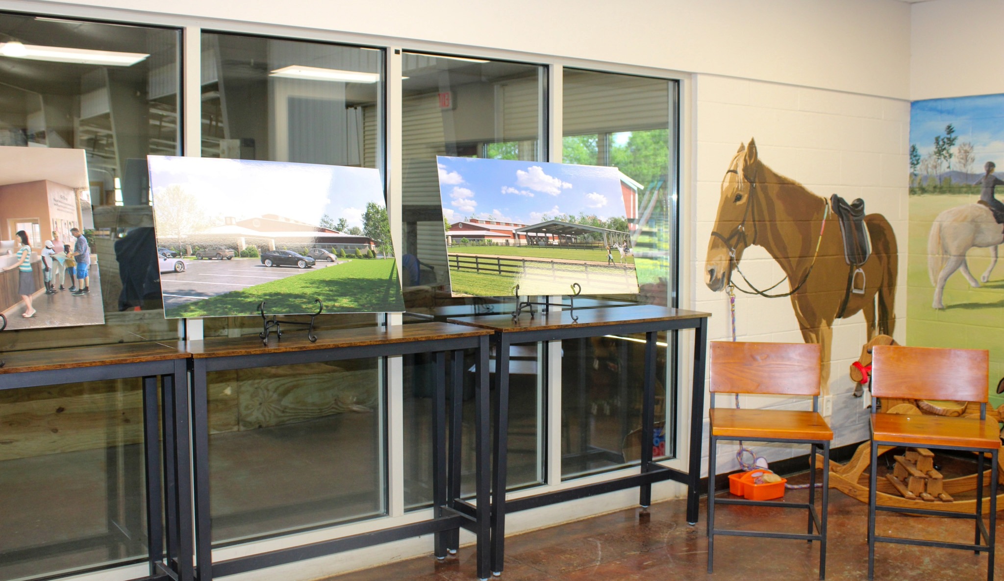 Saddle Up expansion renderings displayed indoors showing planned therapy facilities in Franklin TN
