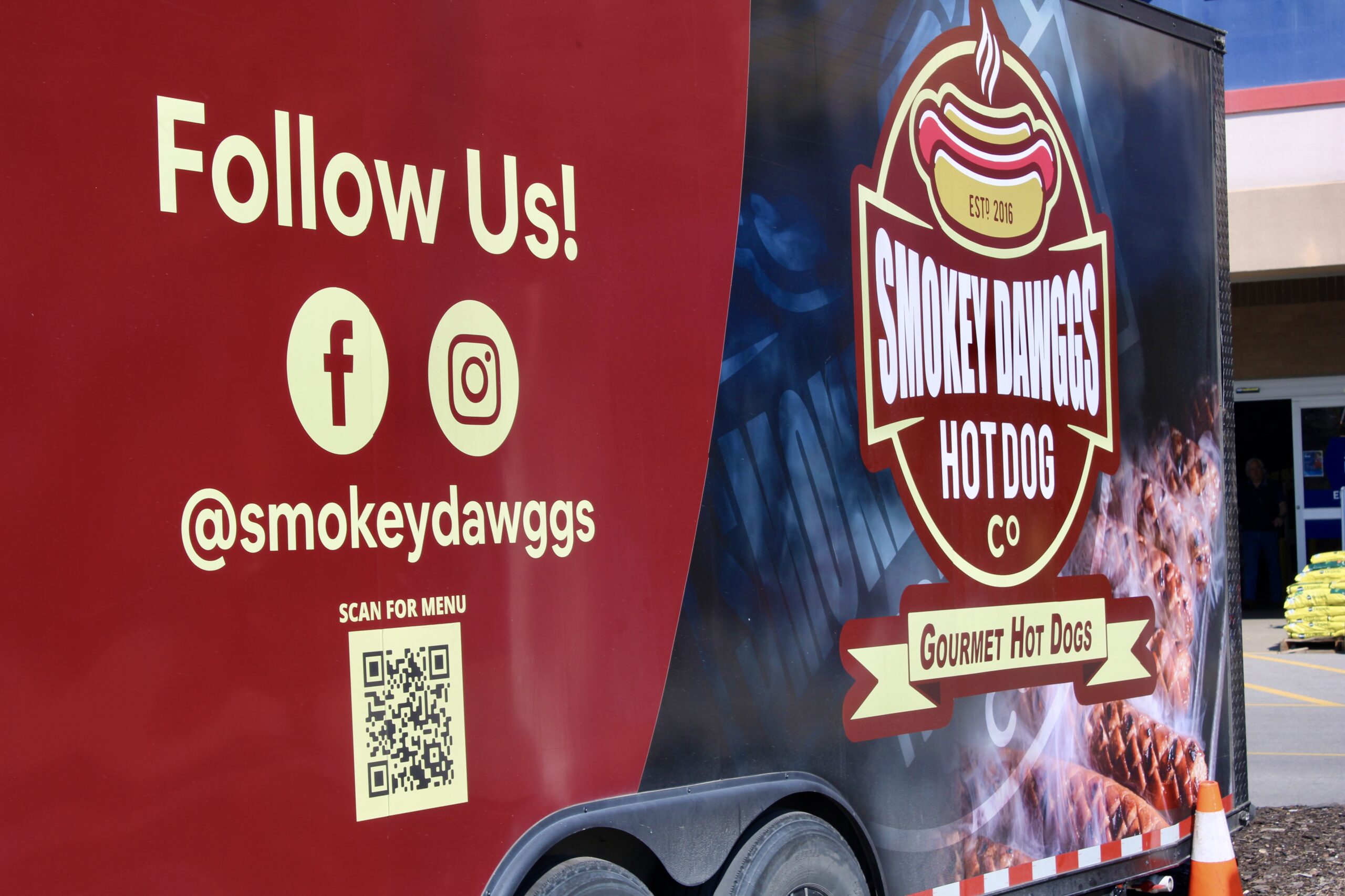 Smokey Dawggs food truck logo and social media handle displayed on truck in Franklin Tennessee