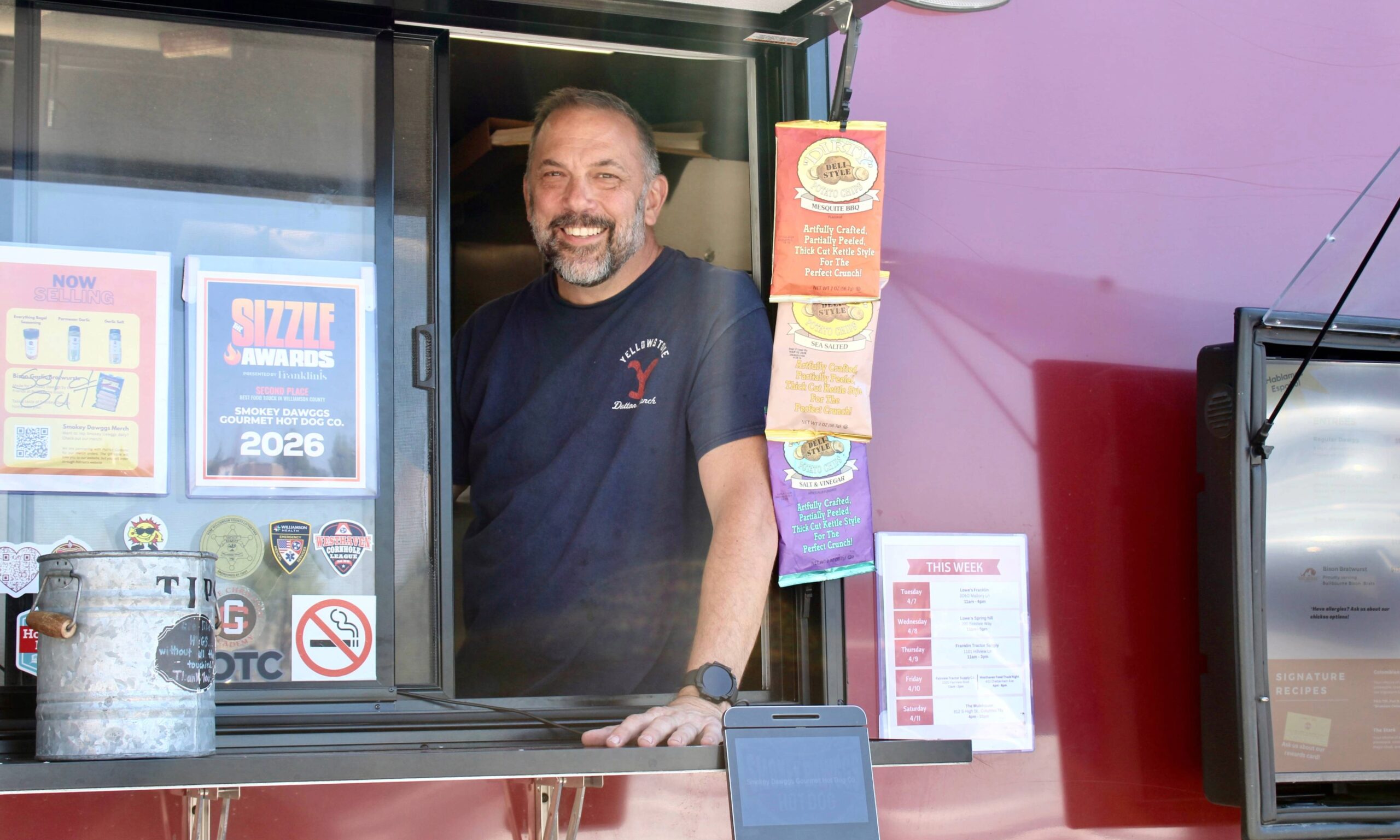 Jim Hendel at Smokey Dawggs food truck window in Franklin Tennessee serving customers and displaying 2026 Sizzle Award
