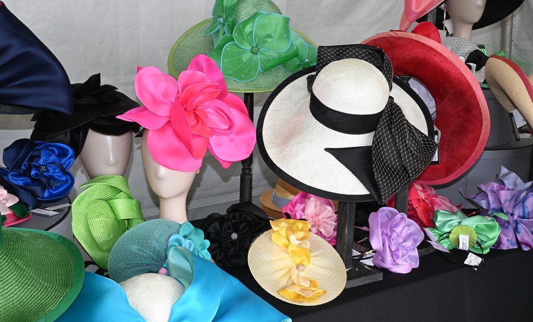 Colorful collection of hats and fascinators by Christine Moore displayed for Iroquois Steeplechase fashion in Nashville