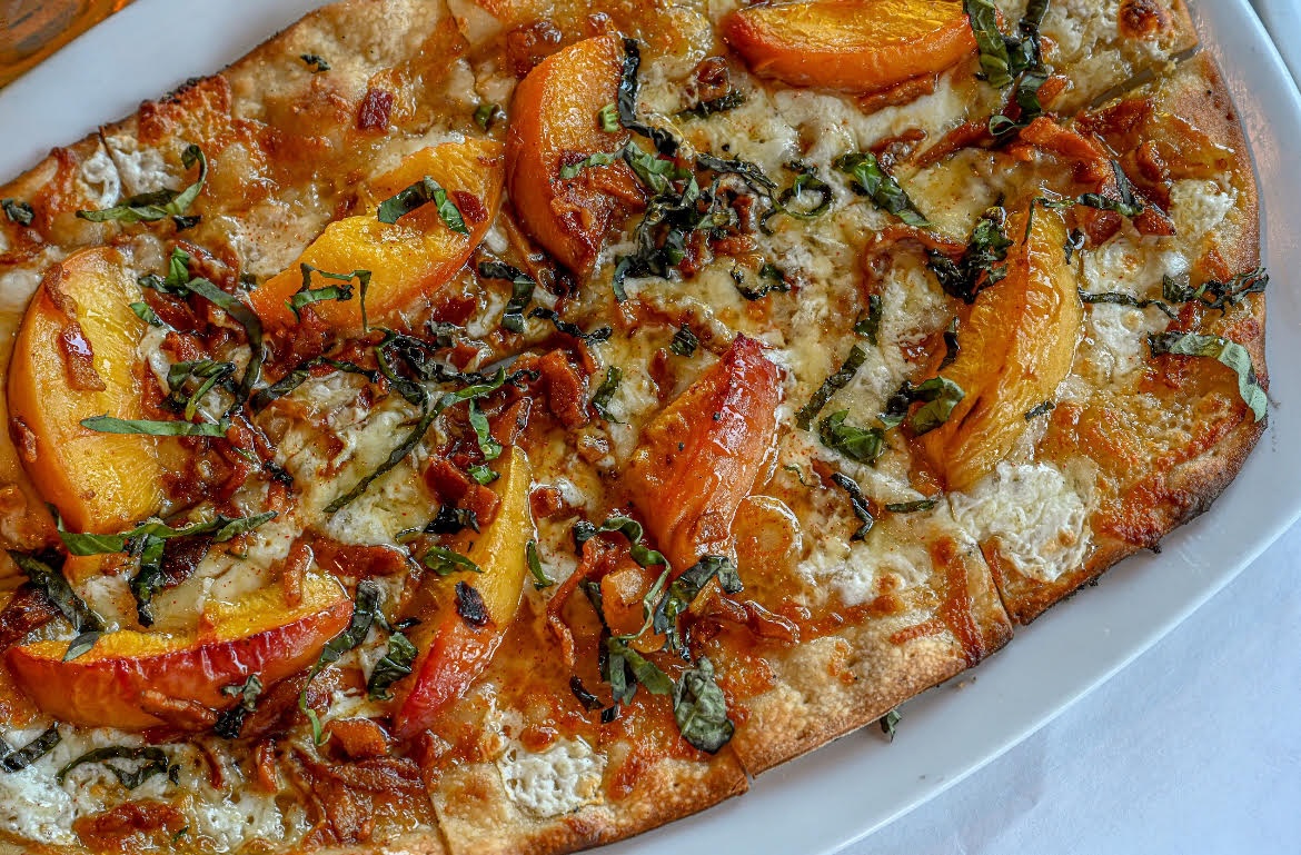 Amerigo Italian Restaurants in Brentwood, and Nashville, TN offer limited time Summer Menu, Roasted Peach Pizza with hot honey.