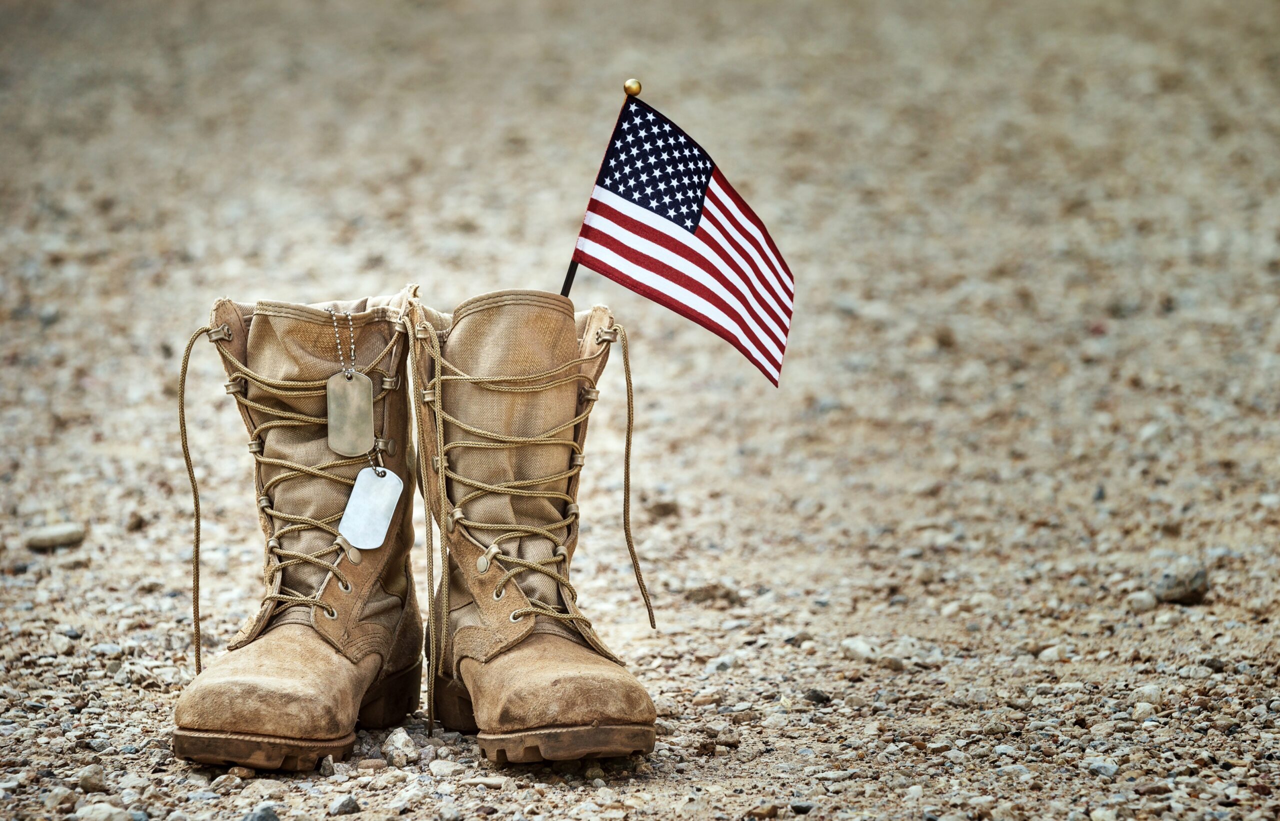 Boots of Honor display featuring combat boots, military dog tags, and an American flag honoring fallen U.S. service members in Franklin, TN.