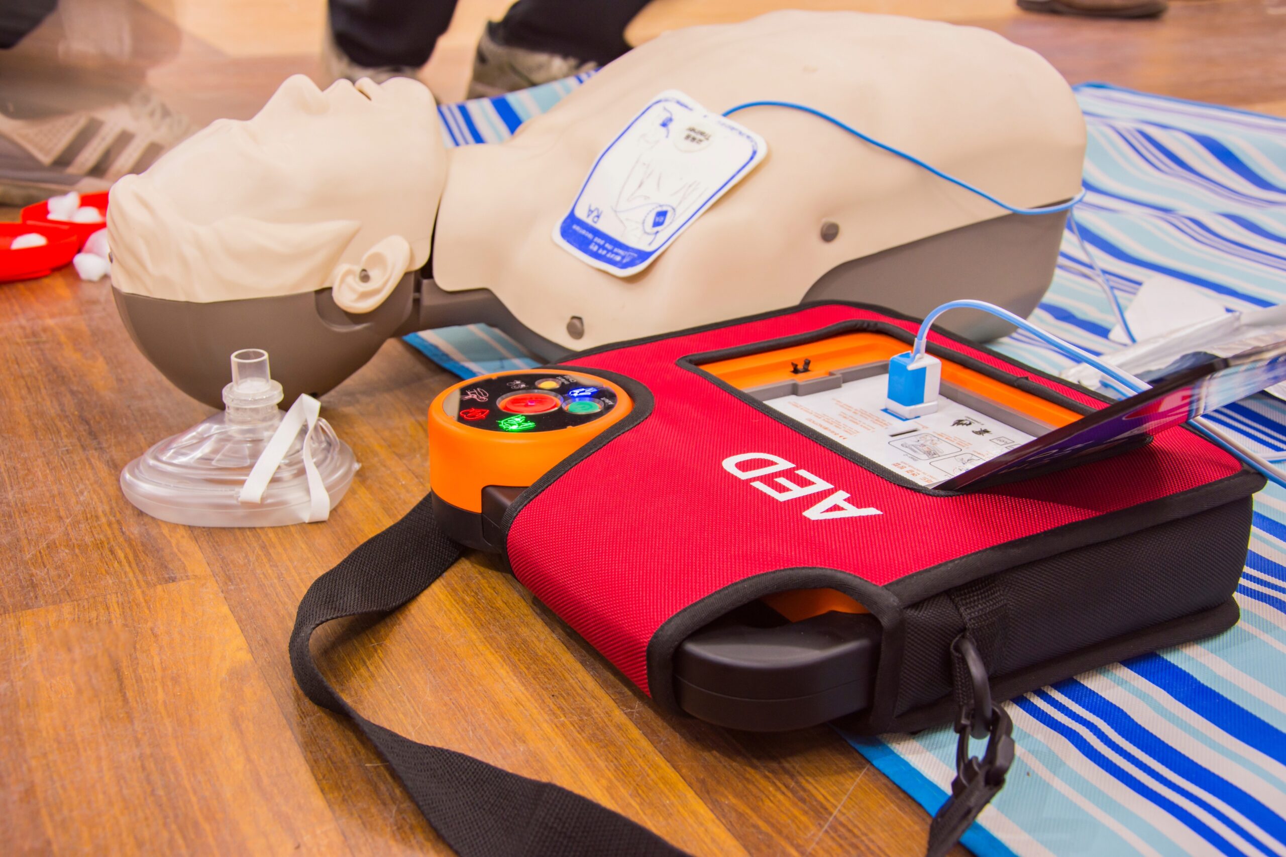 Franklin TN CPR training equipment with an AED trainer, CPR mannequin, and rescue breathing mask for emergency response practice.