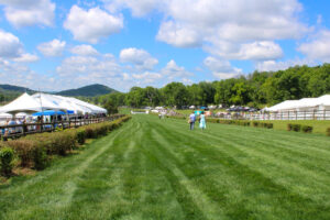 Horses race and spectators gather at the Iroquois Steeplechase in Nashville, Tennessee during the annual steeplechase event.