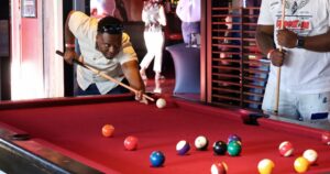 Kings Dining & Entertainment in Franklin, TN, game room featuring billiards tables and arcade-style entertainment area
