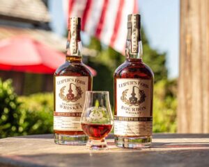 Leiper’s Fork Distillery Nashville Yards Tennessee whiskey and bourbon bottles with a tasting glass on a wooden table.