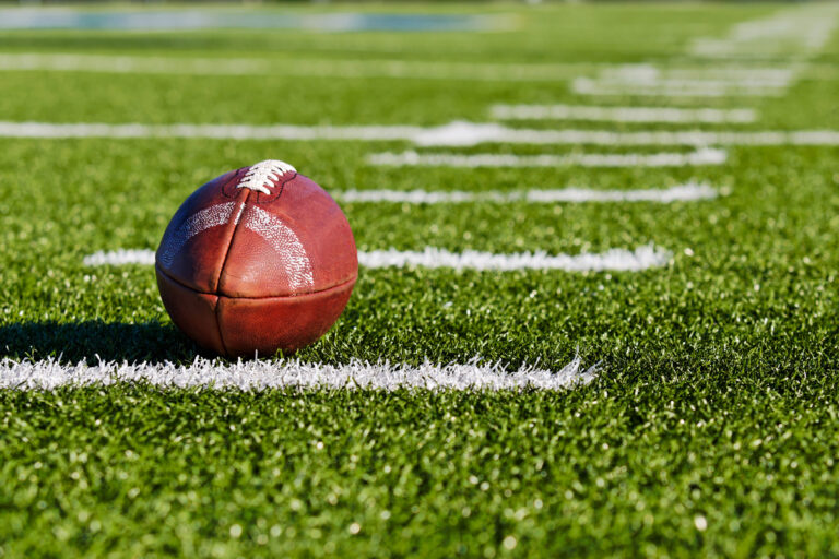 Football on a field representing Super Bowl Nashville 2030 and the possibility of Super Bowl LXIV coming to the new Nissan Stadium.