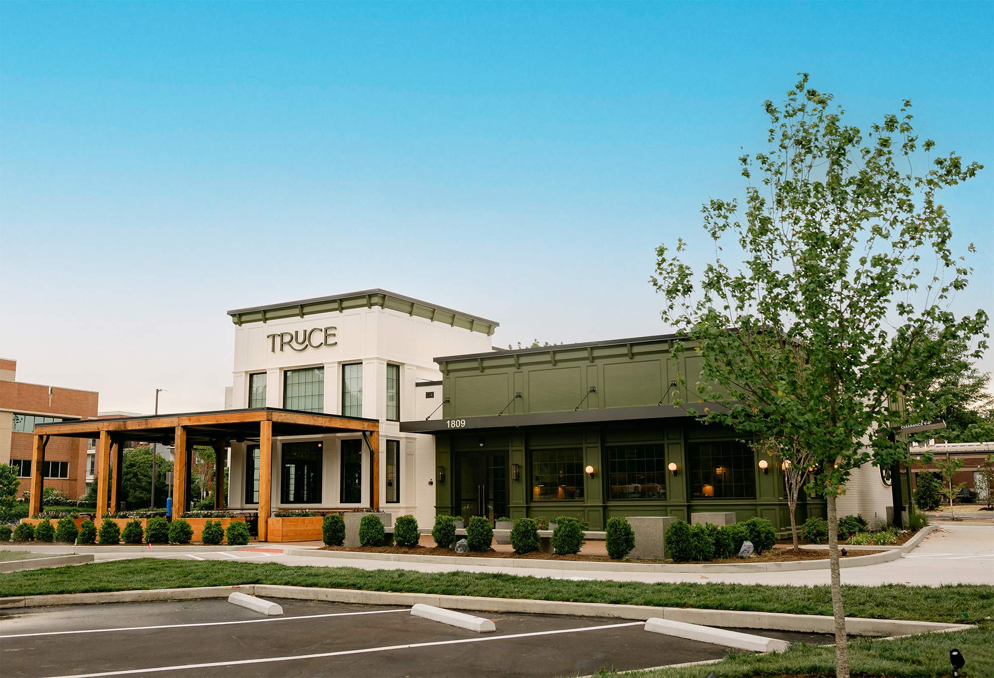 Truce Brentwood restaurant exterior with green and white building, covered entrance, landscaping, and parking area in Brentwood, Tennessee.