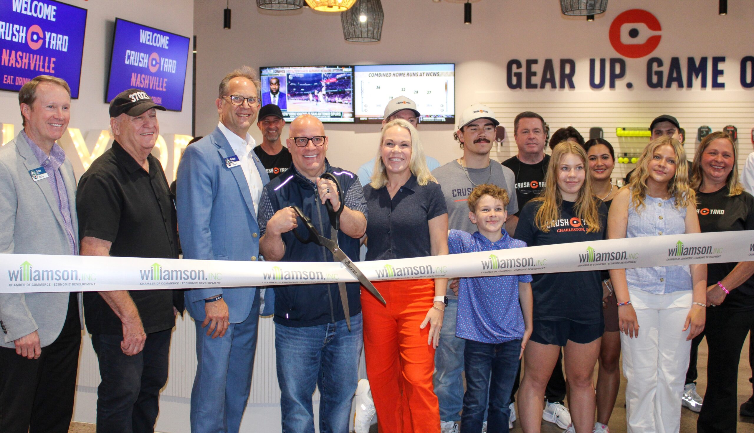 Crush Yard Nashville ribbon cutting in Brentwood, TN, with David and Jennifer Hack, Brentwood Mayor Andrews, and team members gathered inside the new pickleball and entertainment venue.