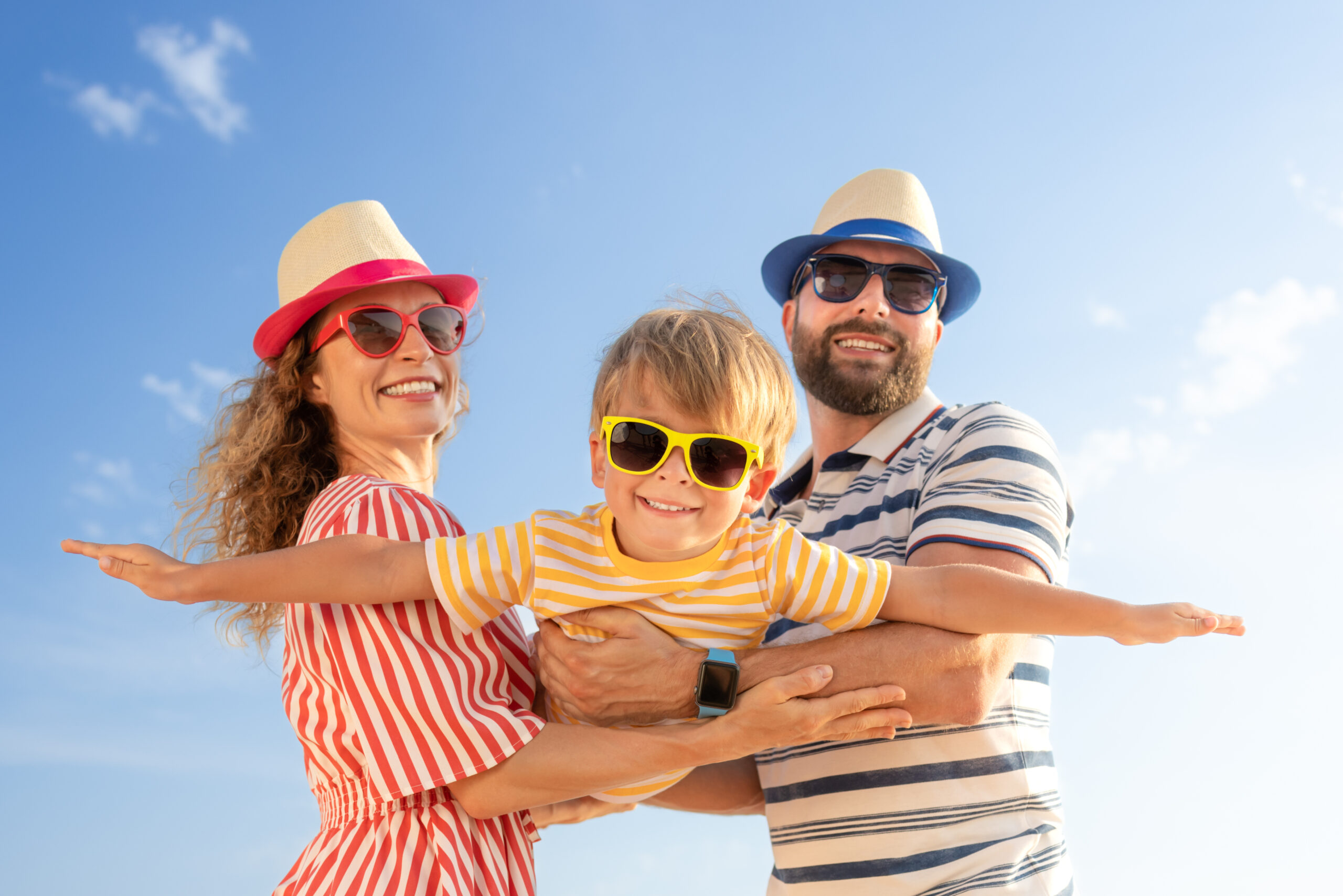 Family wearing sunglasses and summer hats outdoors, representing summer activities in Franklin and Williamson County, TN.