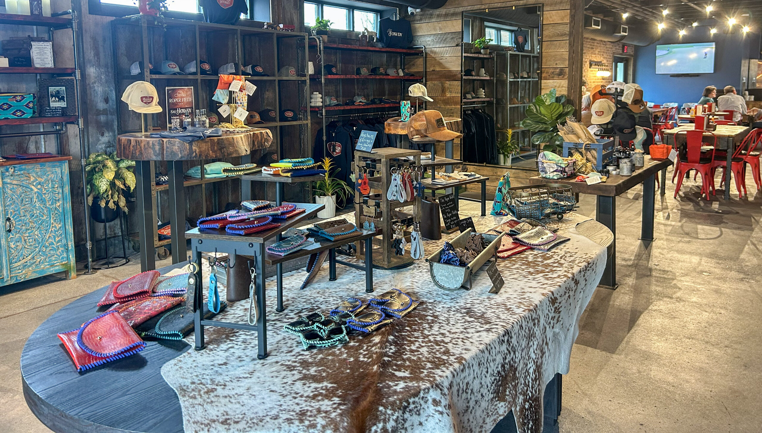 Retail and merchandise area inside The Franklin Butchery in downtown Franklin TN with branded hats, apparel, leather goods, and curated gifts