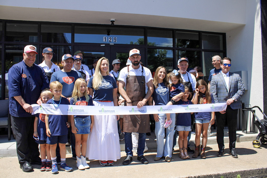 The Franklin Butchery ribbon cutting in downtown Franklin TN with owners, staff, family, and Williamson Inc. gathered outside the shop