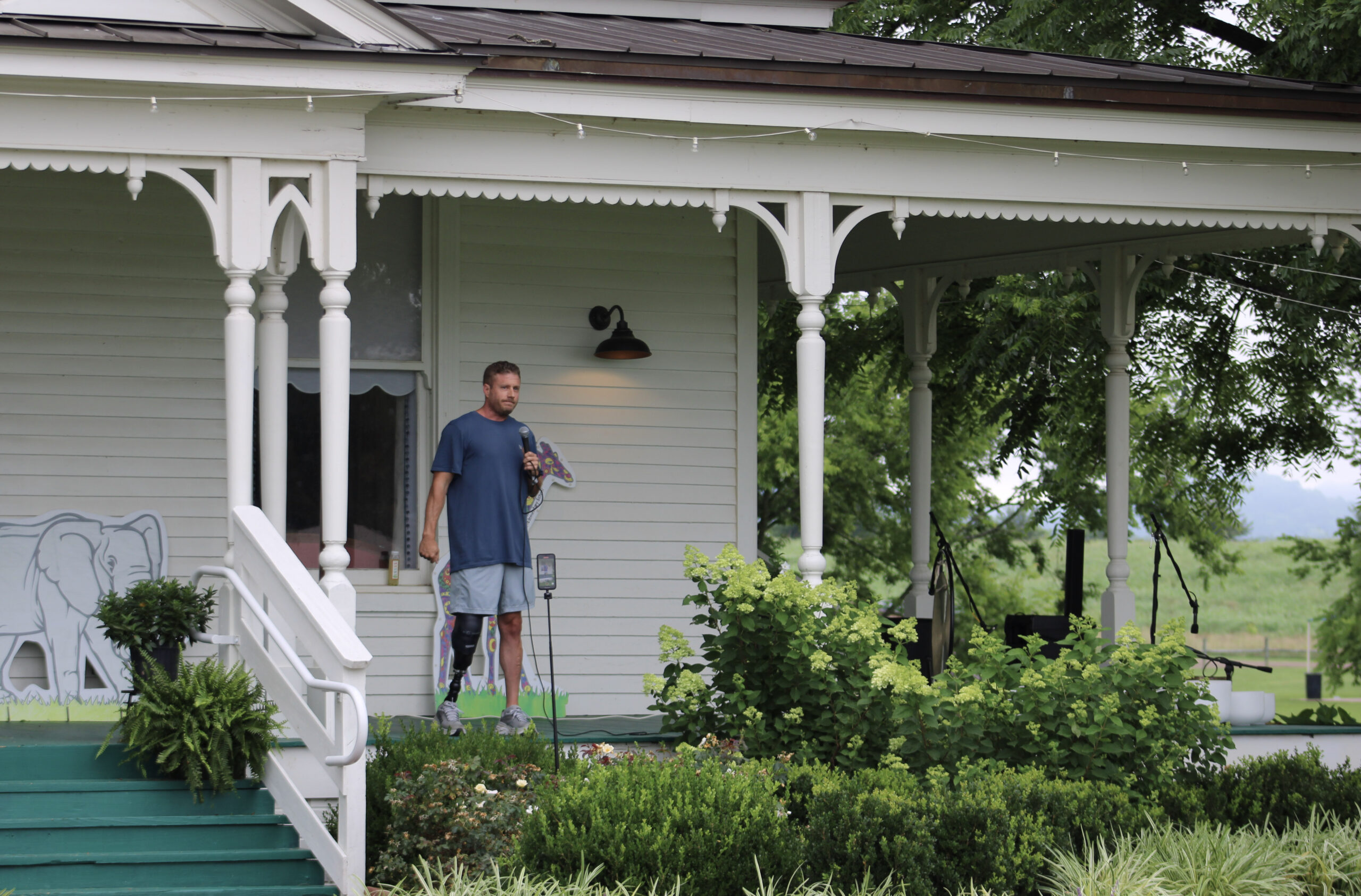 Yoga in the Park Franklin, TN speaker John Mabry addresses participants from the porch at Harlinsdale Farm.