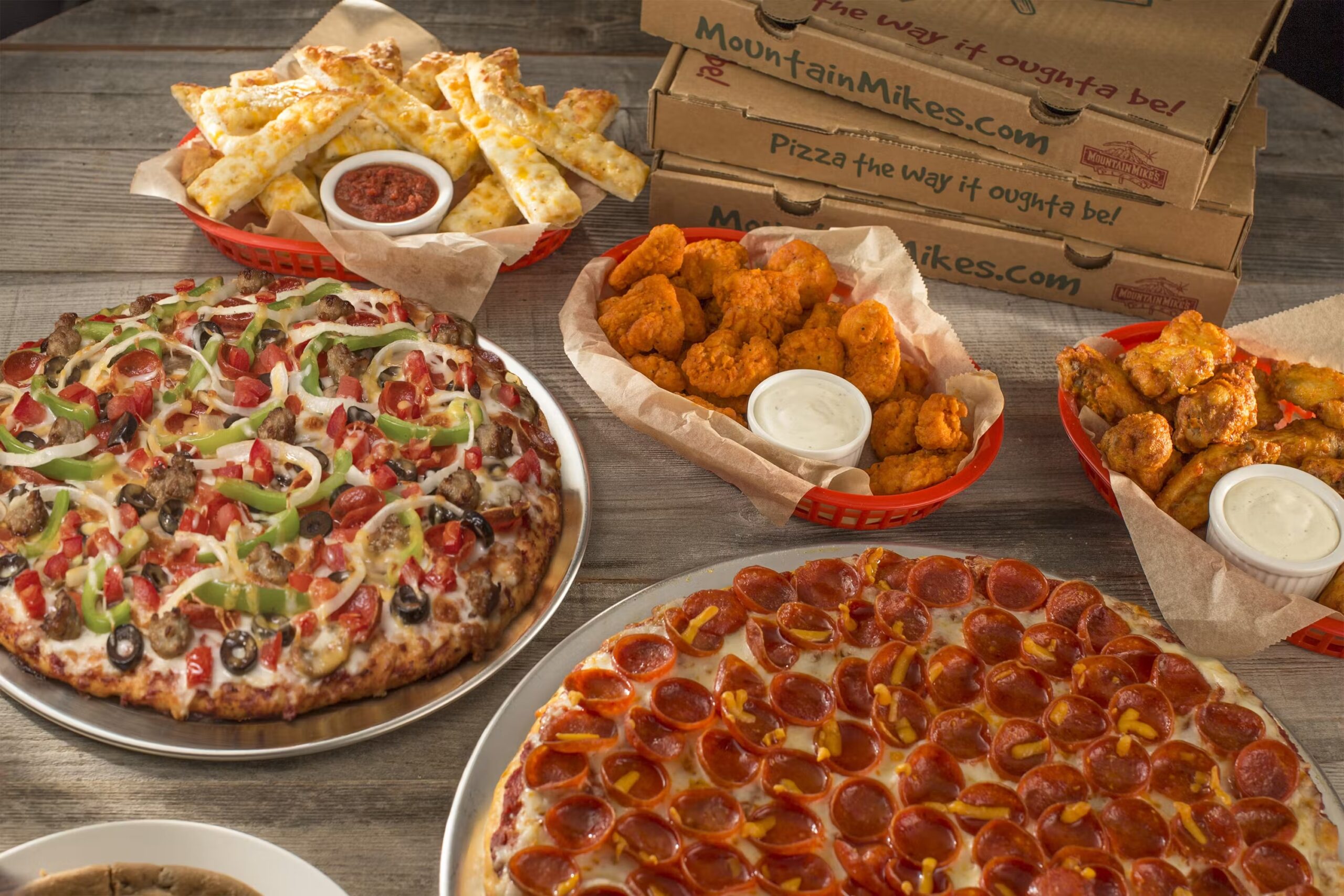 Mountain Mike’s Pizza Nolensville, TN, pizzas, chicken wings, and more food.