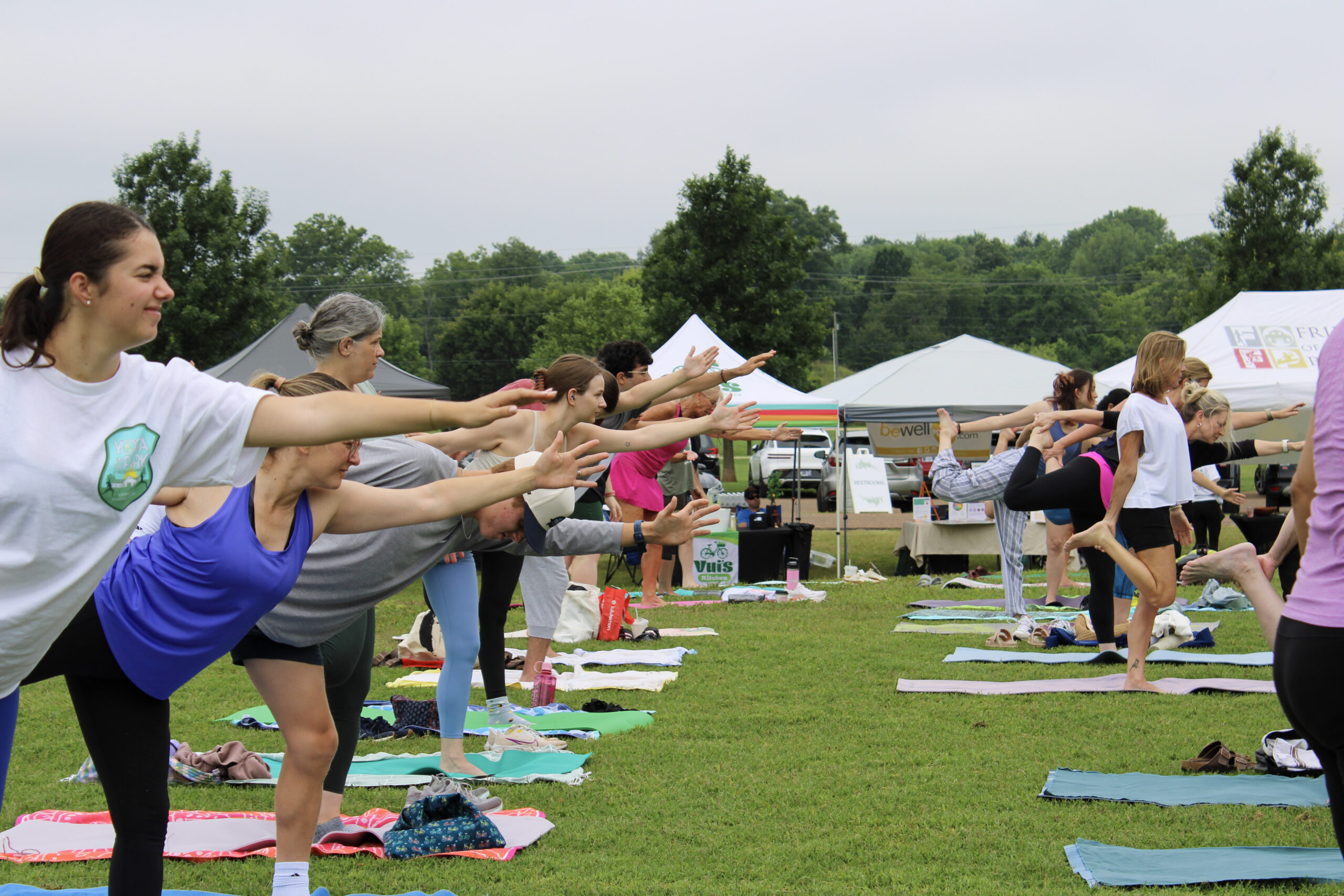 Yoga in the Park Franklin, TN participants practice balance poses during an outdoor class at Harlinsdale Farm.