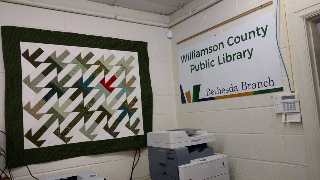 Interior of Bethesda Branch Library in Thompson’s Station, Tennessee, with the Williamson County Public Library sign displayed on the wall.