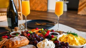 Brunch in Franklin, TN with Mimosas, pancakes, fruit, croissants, bacon, and scrambled eggs.