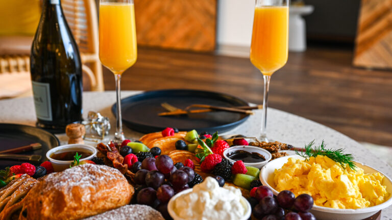 Brunch in Franklin, TN with Mimosas, pancakes, fruit, croissants, bacon, and scrambled eggs.