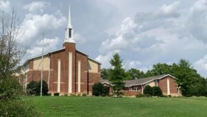 Exterior of The Church of Jesus Christ of Latter-day Saints in Brentwood, Tennessee, with a brick chapel and white steeple.