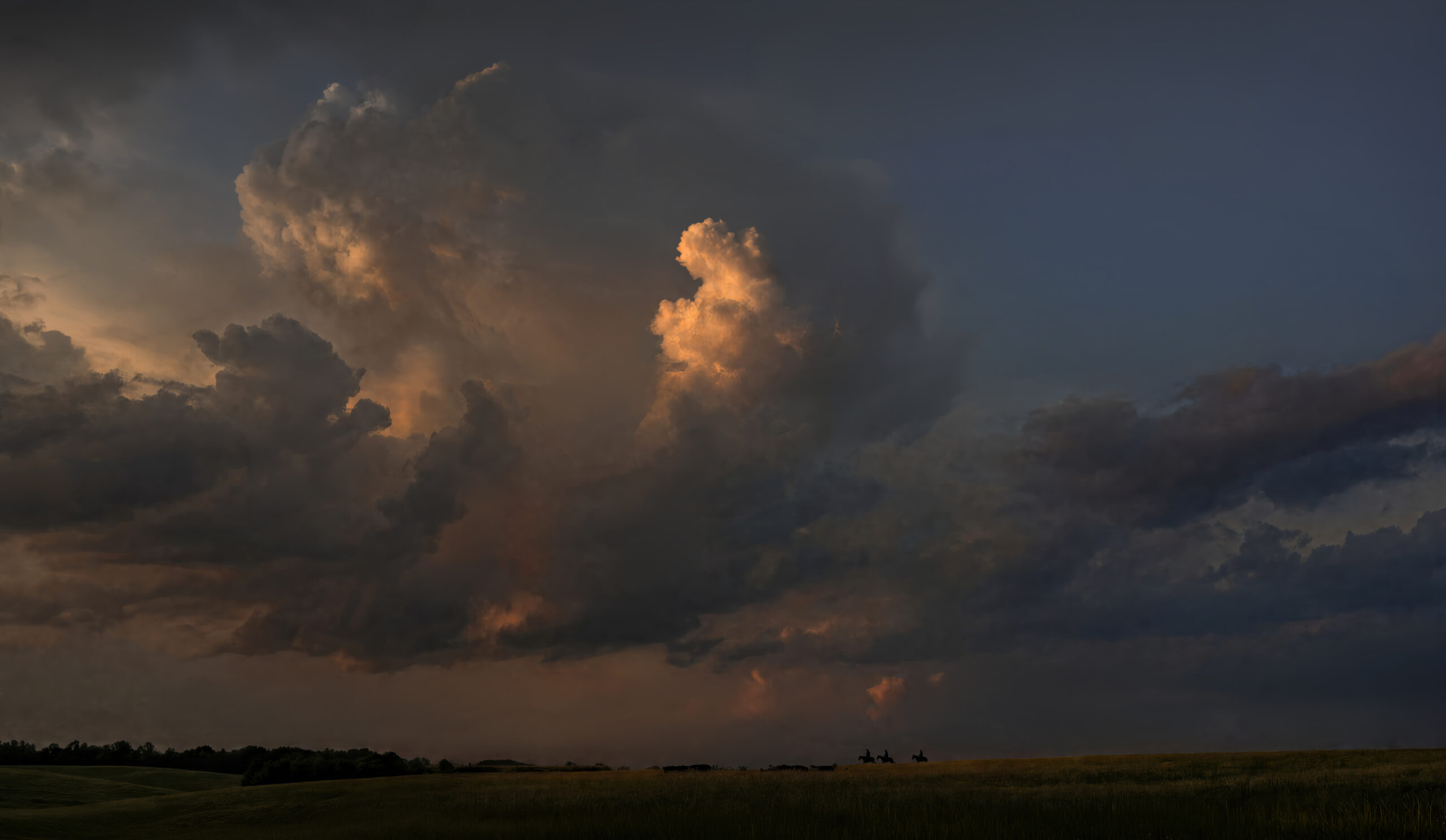 Dane Howard’s TN COWBOY artwork showing riders beneath dramatic storm clouds over a Tennessee landscape