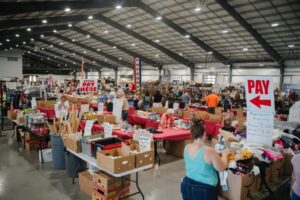Expo Center event area at The Fairgrounds Nashville with vendor tents, crowds, and event activity.