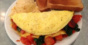 Omelette with tomatoes and spinach, hashbrown casserole, and toast at Franklin Mercantile Deli in Franklin, TN.