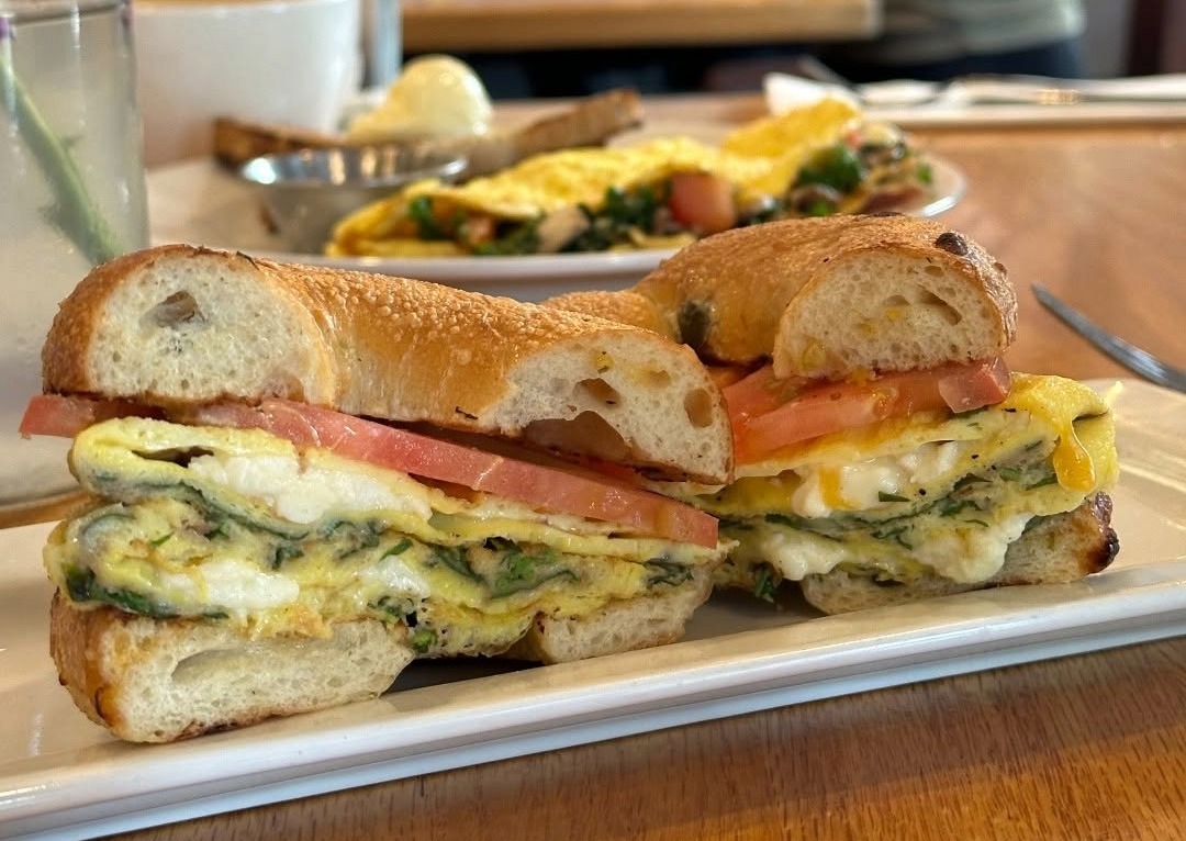 Breakfast sandwich with eggs, tomato, and greens at Frothy Monkey in Franklin, TN.