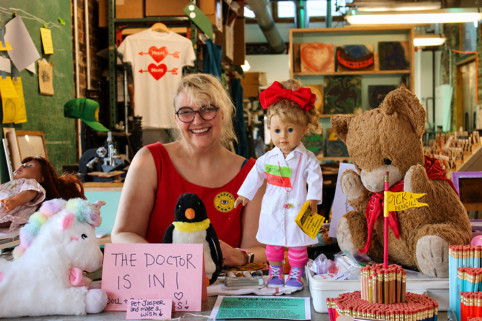 Jeni Hankins with dolls and stuffed animals at the Jeniland Doll & Bear Hospital residency at Experimart
