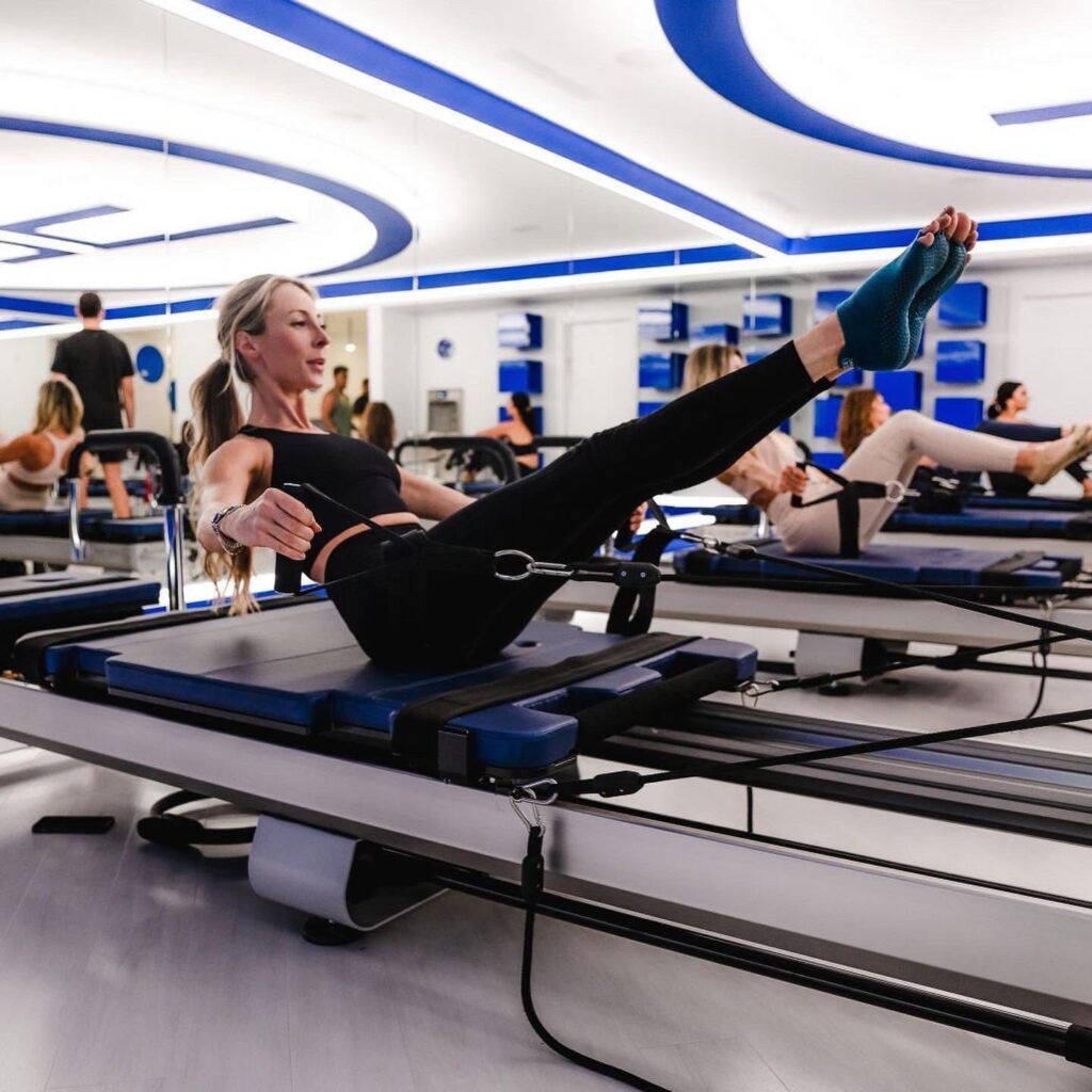Woman taking a reformer Pilates class at JETSET Pilates in Brentwood, Tennessee