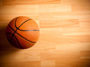 Legacy Courts in Franklin, TN, an official orange ball on a hardwood basketball court.