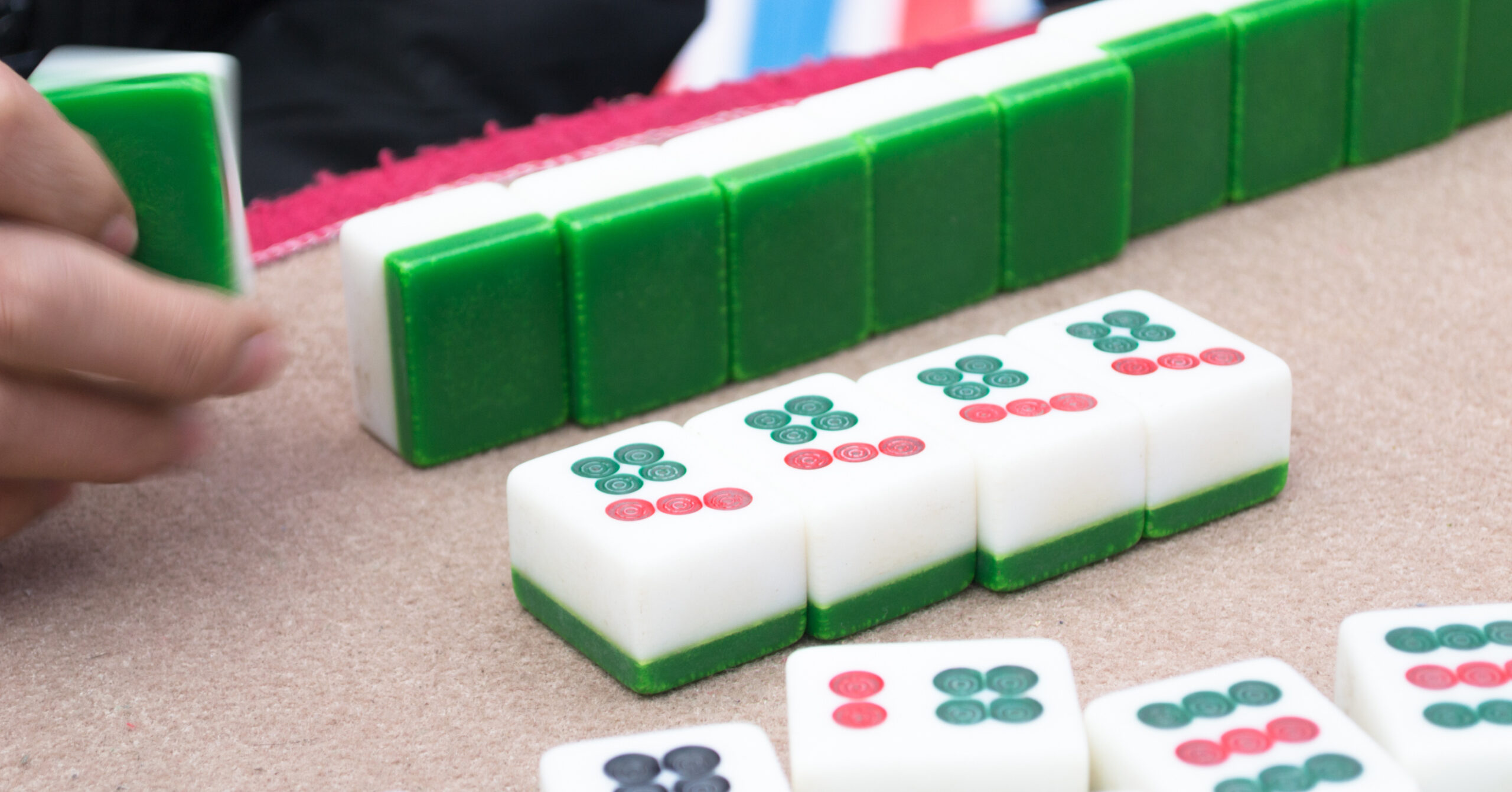 The Brentwood and Franklin library offer Mahjong programs for Mahjong players who know the basics, and also beginner instructions. Green and white Mahjong tiles arranged during a library open-play game. 