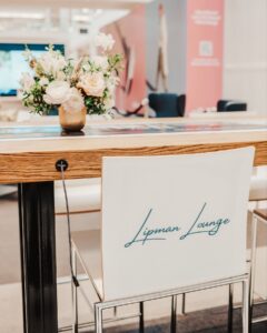 The Lipman Lounge at The Mall at Green Hills in Nashville, featuring a branded chair and floral arrangement in its client and community space.