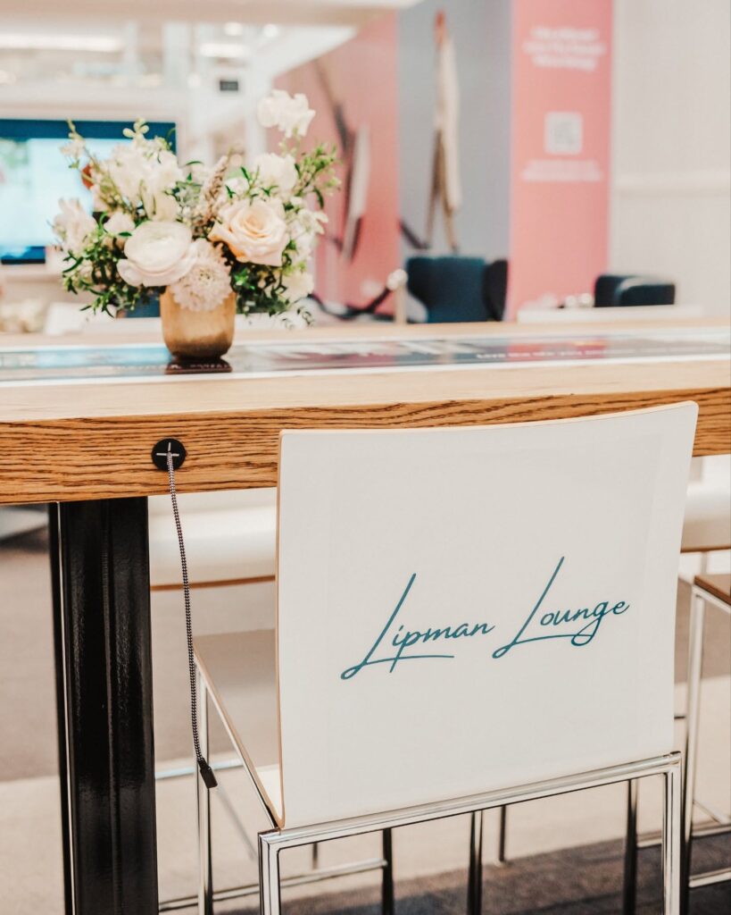 The Lipman Lounge at The Mall at Green Hills in Nashville, featuring a branded chair and floral arrangement in its client and community space.