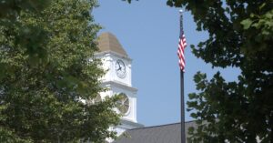 Clock tower and American flag along Main Street in Spring Hill, Tennessee.