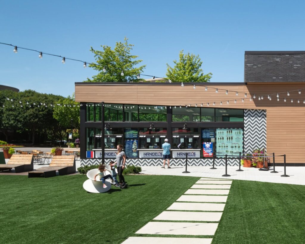 The Green at Meridian Cool Springs in Franklin, Tennessee, with lawn seating, string lights, and nearby shops.