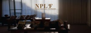 Nashville Public Library Foundation logo displayed inside Nashville Public Library with books arranged on tables.