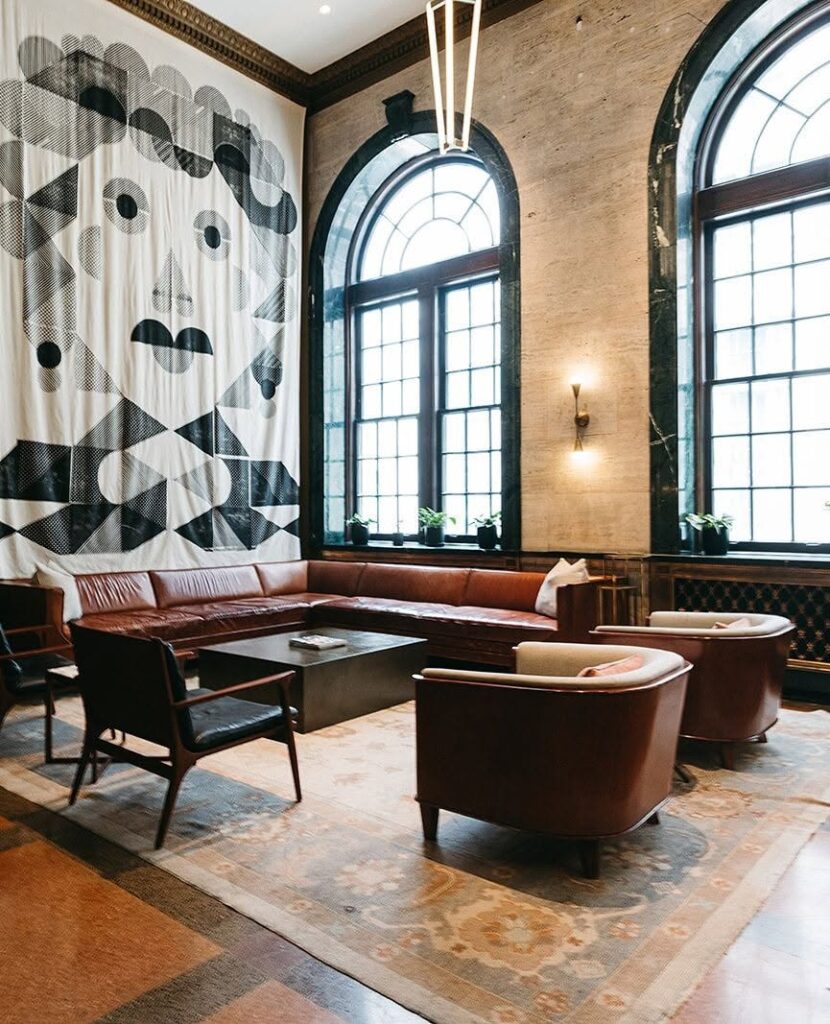 Lounge seating and tall arched windows inside Noelle hotel in downtown Nashville, Tennessee.