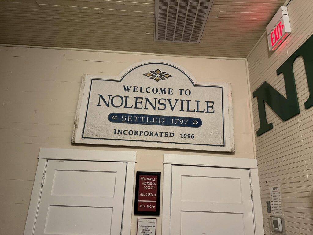 Welcome to Nolensville historic sign displayed inside a Nolensville Historical Society building in Nolensville, Tennessee.