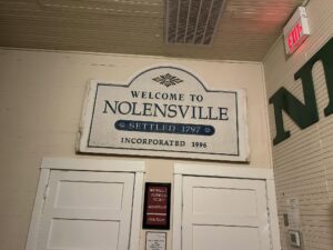 Welcome to Nolensville historic sign displayed inside a Nolensville Historical Society building in Nolensville, Tennessee.