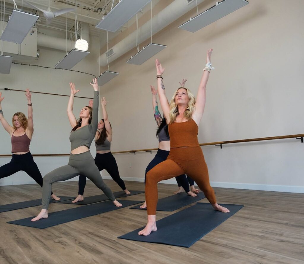 Group participating in a hot yoga class at Nolo Sol Hot Yoga in Franklin, Tennessee.