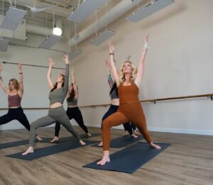 Group participating in a hot yoga class at Nolo Sol Hot Yoga in Franklin, Tennessee.