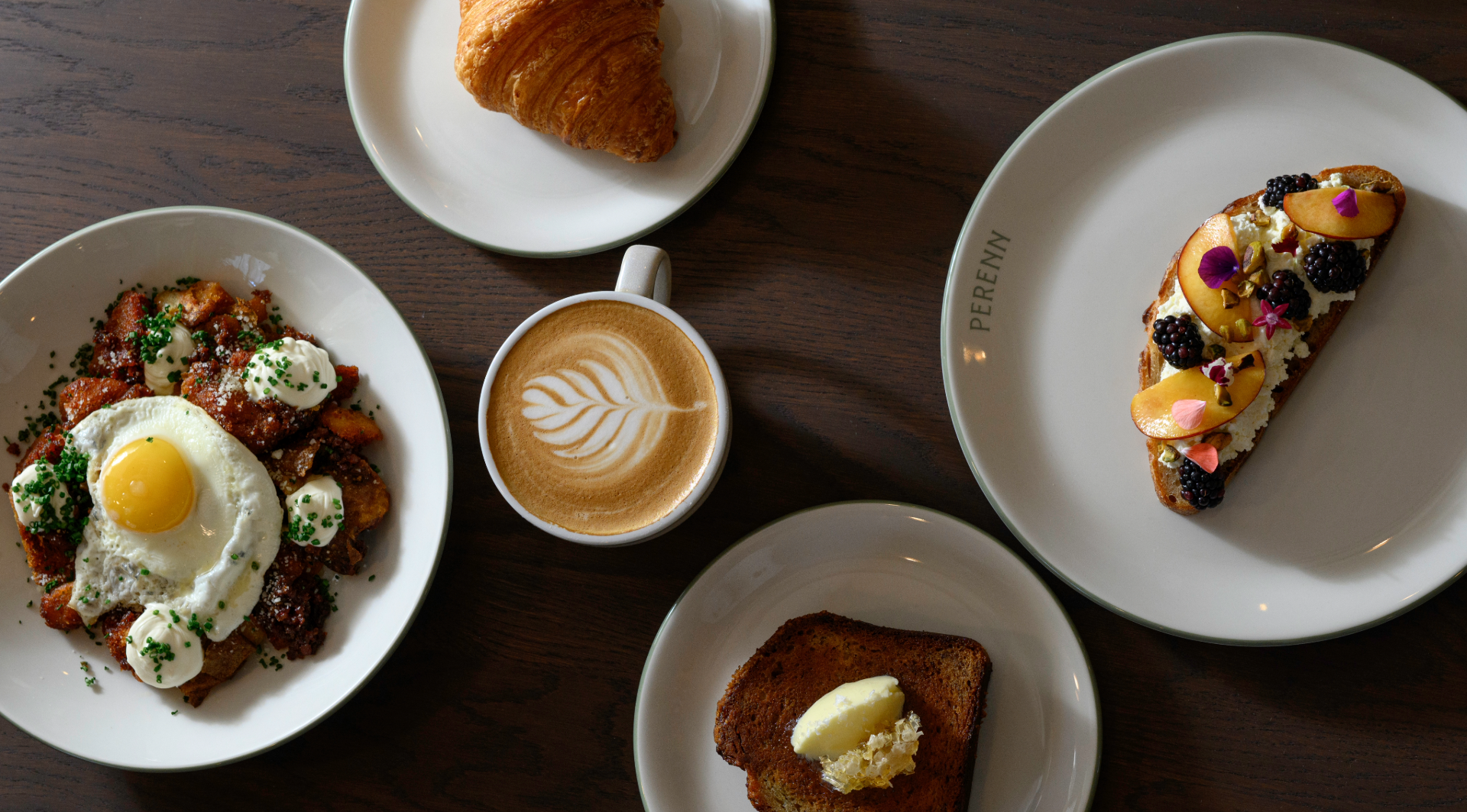 Brunch dishes, coffee, croissant, and toast at Perenn Bakery in Franklin, TN.
