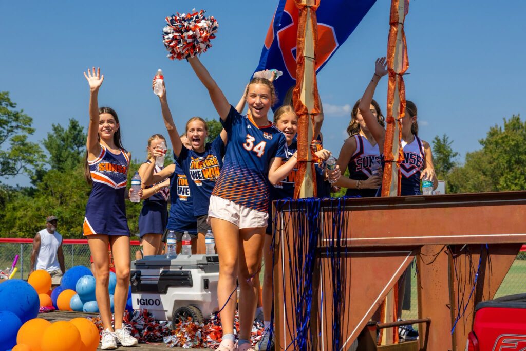 Ravenwood High School students and cheerleaders celebrating outdoors during a school event in Brentwood, Tennessee.