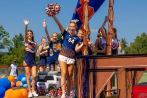Ravenwood High School students and cheerleaders celebrating outdoors during a school event in Brentwood, Tennessee.