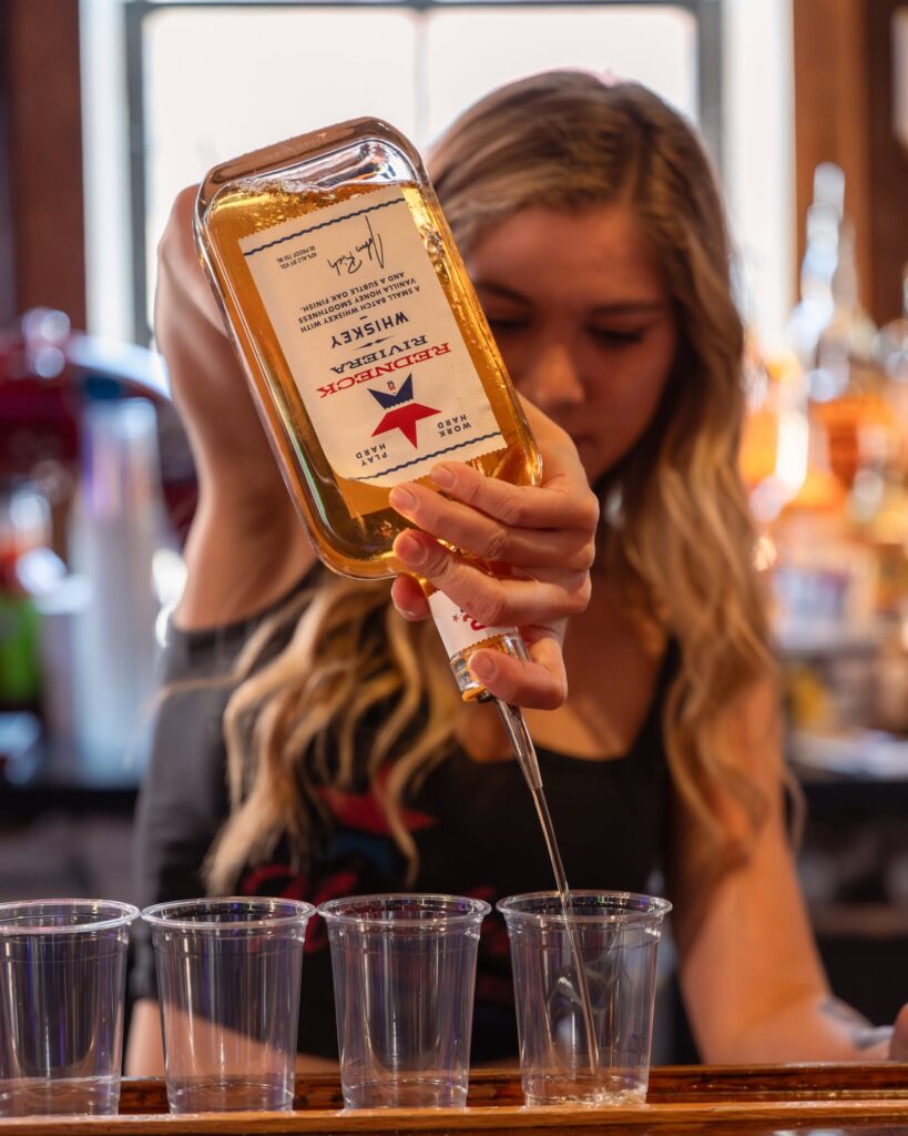Bartender pouring Redneck Riviera Whiskey at Redneck Riviera in downtown Nashville, Tennessee.